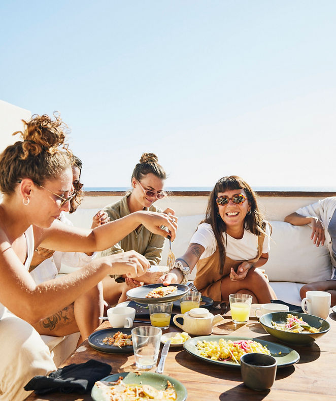 A group of people are having a meal in the Langham restaurant and earn Brilliant by Langham loyalty points.